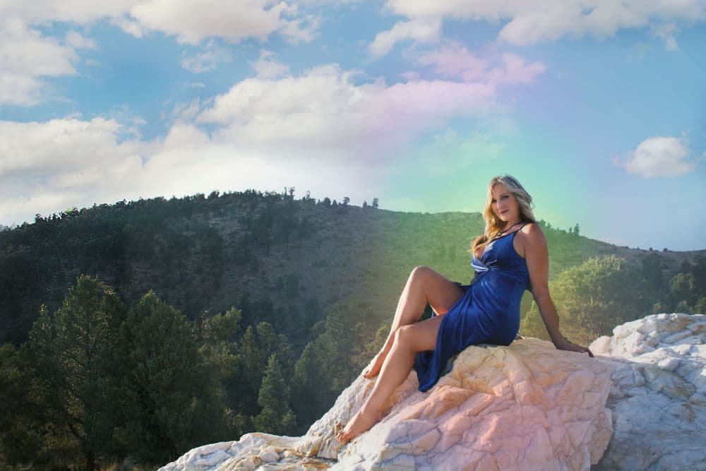 Elayne Le Monde sitting on a crystal rock